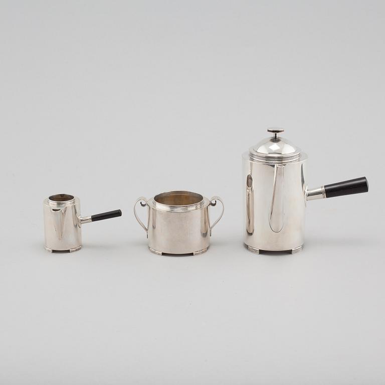 A silver coffee pot, a creamer and a sugar bowl by C F Carlman in Stockholm, 1937 and 1945.