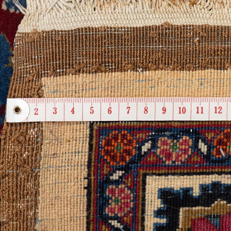 A semi-antique Mashad carpet, signed Saber, c. 401 x 300 cm.