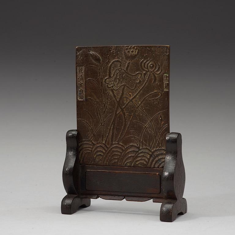 A bronze table screen, Qing dynasty.