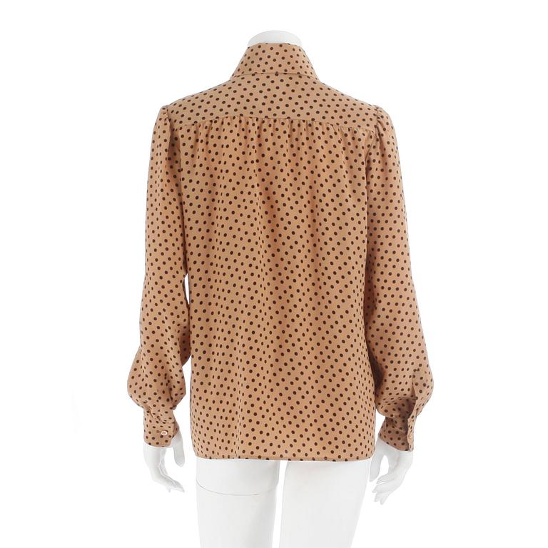 YVES SAINT LAURENT, a beige and black polka dotted blouse.