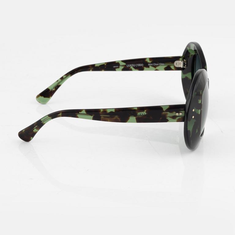 Oliver Goldsmith, a pair of green "Uuksu" sunglasses.