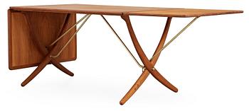 460. A Hans J Wegner oak dinner table with brass mounts by Andreas Tuck, Denmark, 1950-60's.