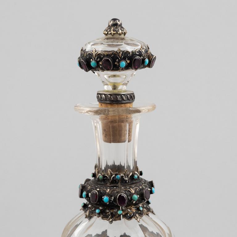 Flask with stopper, glass with mounts of partially gilded silver, late 19th century.