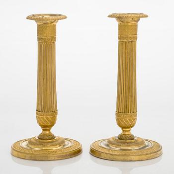 A pair of French gilded Empire candlesticks, early 19th century.