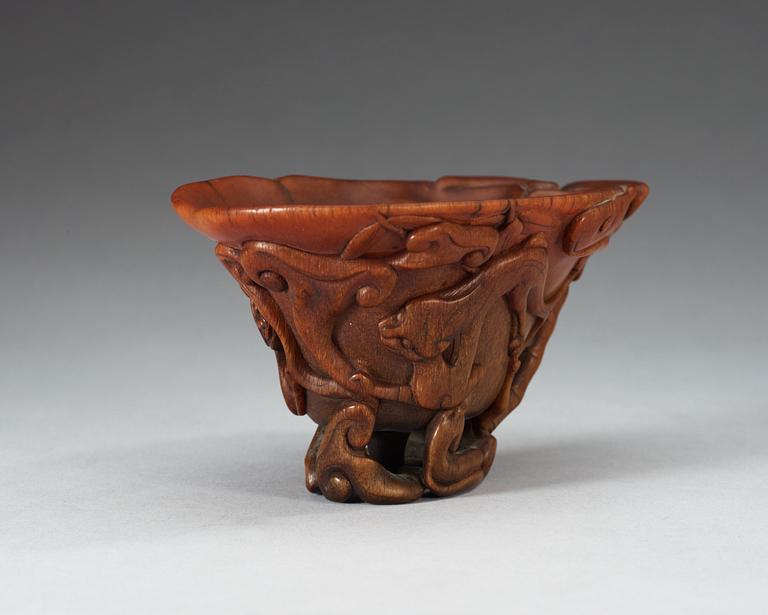 A finely carved rhinoceros libation cup, Qing dynasty, Kangxi (1662-1722).