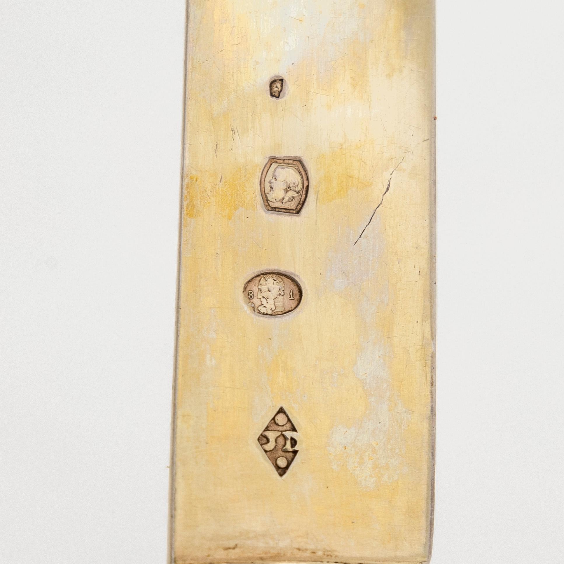 A set of eleven gilt silver dessert knives with mother-of-pearl stems, Paris 1819-1838.