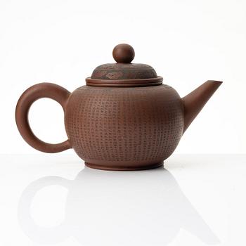 A 'calligraphy' yixing teapot, China, later part of the 1900s.