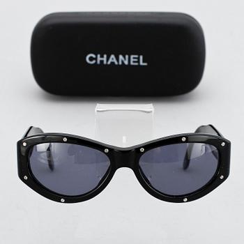 A pair of sunglasses by Chanel.