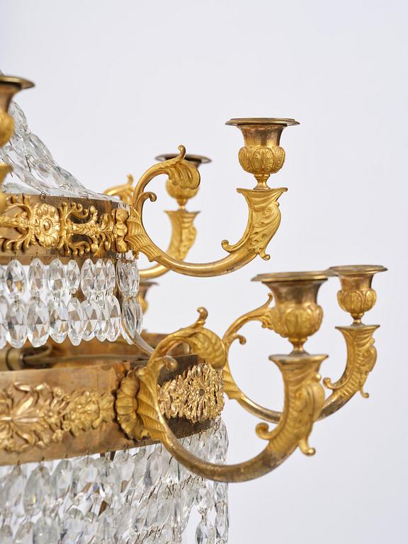 An ormolu and cut glass sixteen-branch Empire chandelier, Paris, early 19th century.
