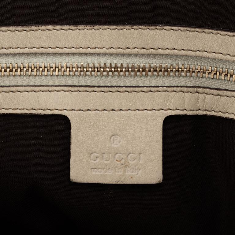 Gucci, a cream leather handbag.