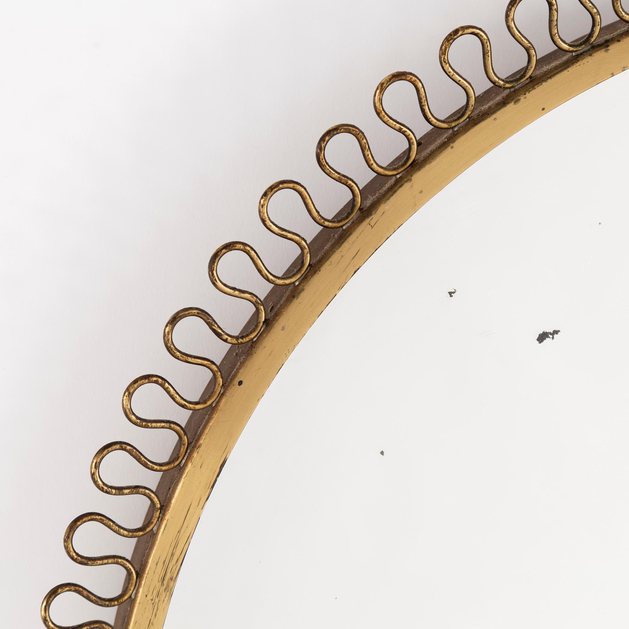 A mid 20th century brass frame mirror.