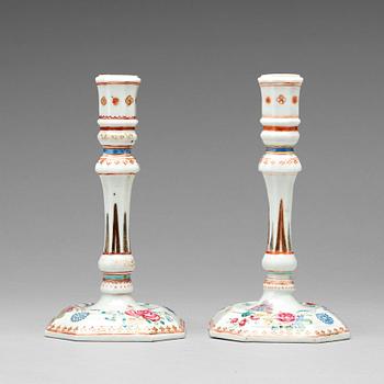 A pair of famille rose candle sticks, Qing dynasty, Qianlong (1736-95).