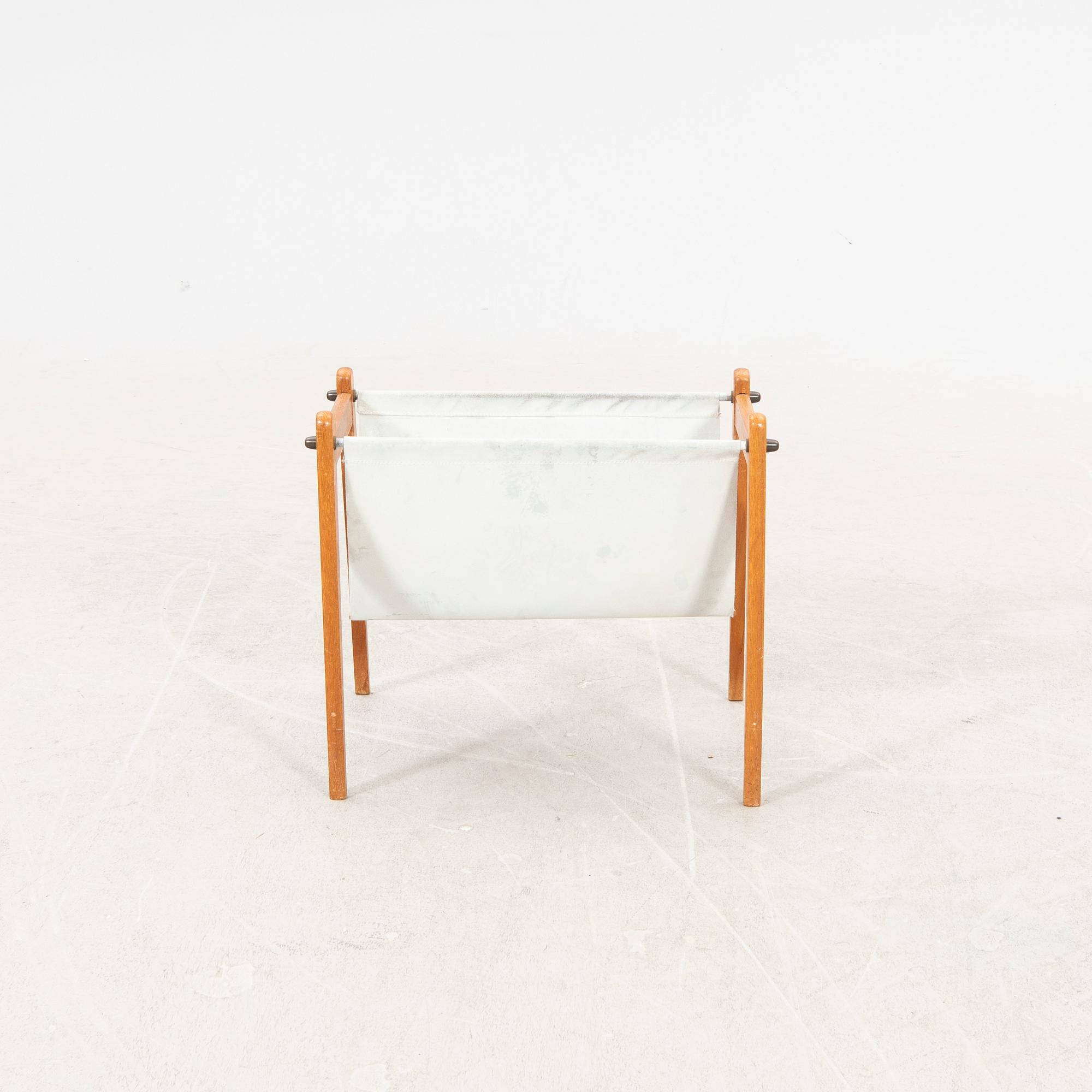 A 1960s teak newspaper holder.