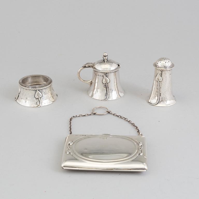 An Art Nouveau set of a silver salt cellar, pepper shaker and mustard pot, Birmingham, 1907-08 and satchel, 1906.