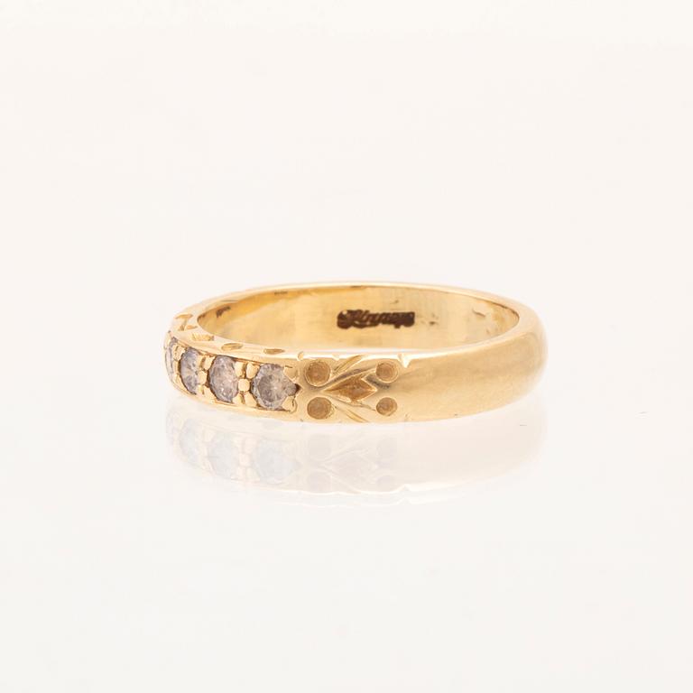 An 18K gold half-eternity ring set with round brilliant-cut diamonds.