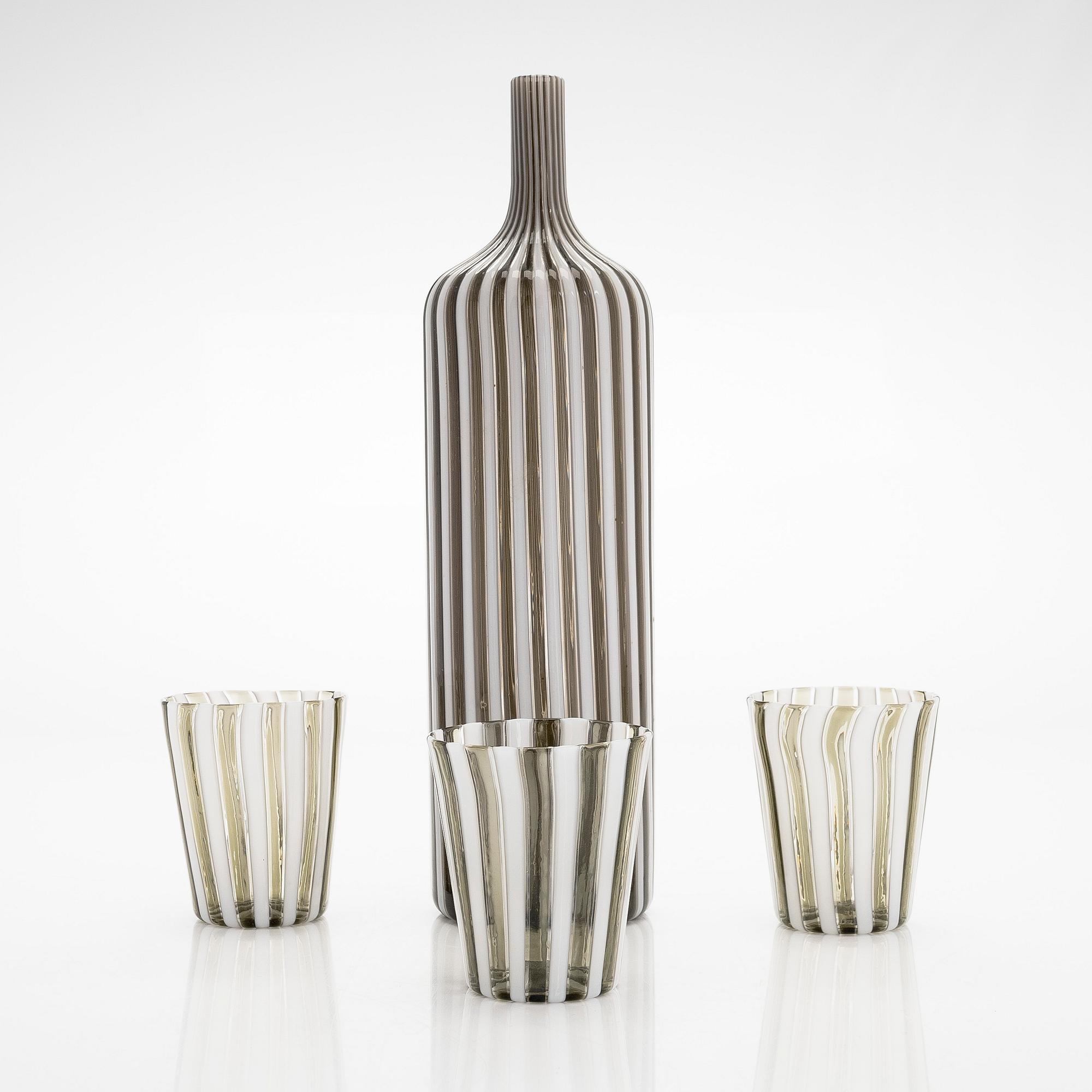 Gio Ponti, a glass bottle '4500' signed Venini, Murano and three drinking glasses, Italy.