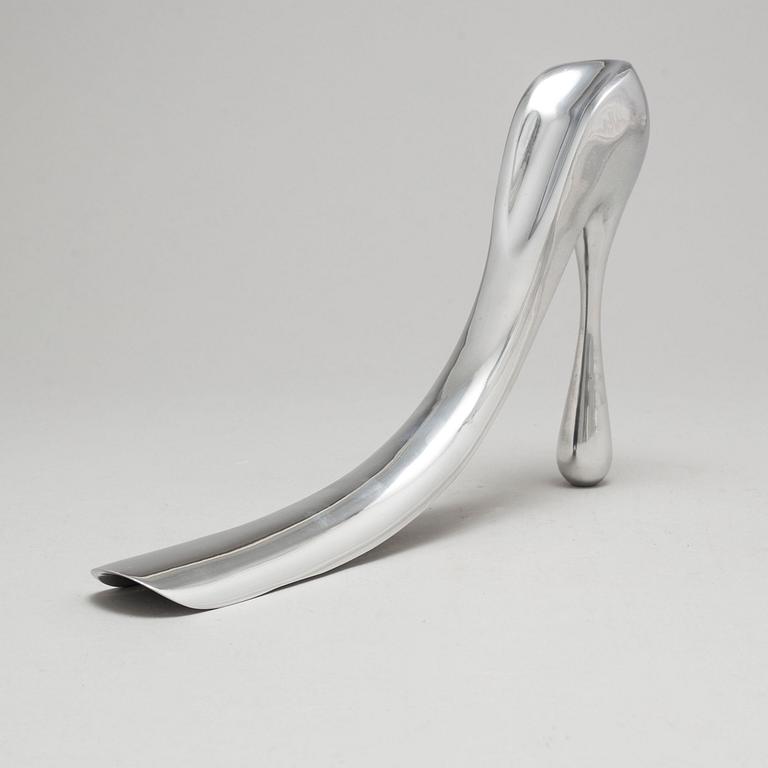 A metal shoe horn by Manolo Blahnik, with orignal box.