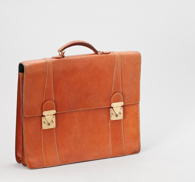 A 1990s natural cowhide leather brief case by Louis Vuitton.
