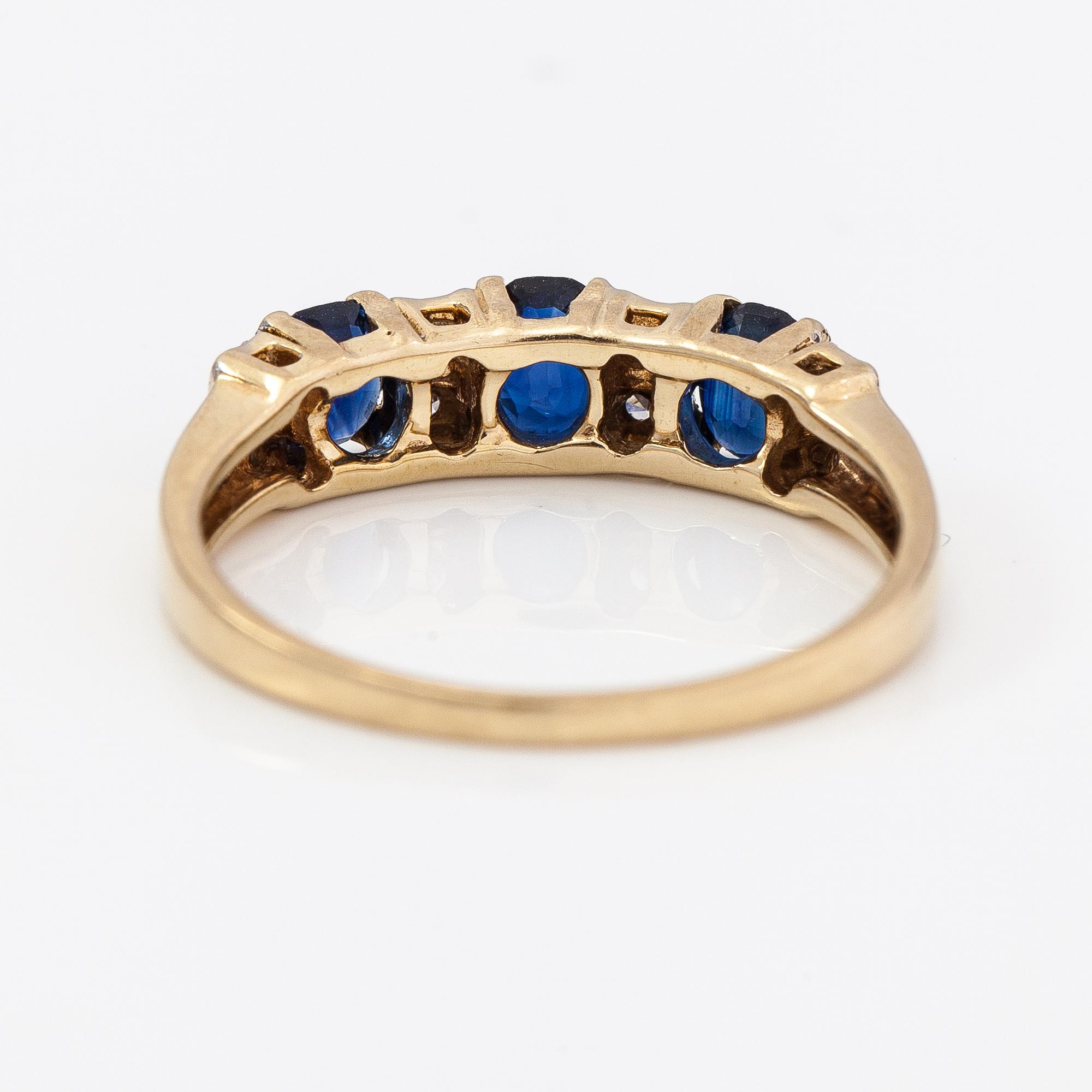 A 14K gold ring with diamonds ca. 0.05 ct and sapphires. Finnish import marks 1990.