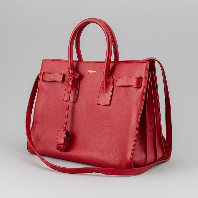 Saint Laurent, a red leather 'Sac du Jour Small' bag.