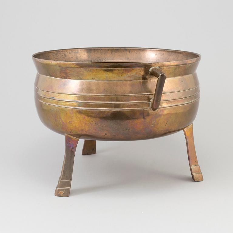 A Swedish 18th/19th century brass pot on three legs.