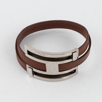 Hermès, a brown leather and palladium metal 'Pousse Pousse' bracelet.