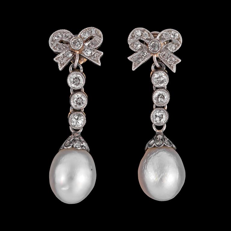 A pair of pearl and diamond earrings.