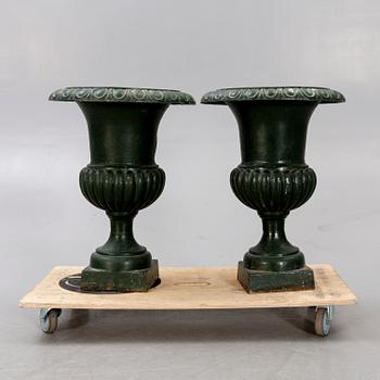 A pair of two 1990s cast iron garden urns.