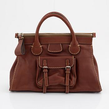 Chloé, a brown leather handbag.