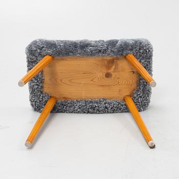 A mid 20th Century stool with new sheepskin upholstery.