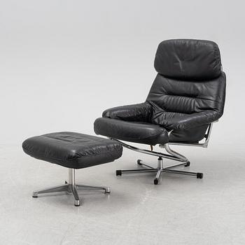 A leather and chrome lounge chair and foot stool, 1970's/80's.