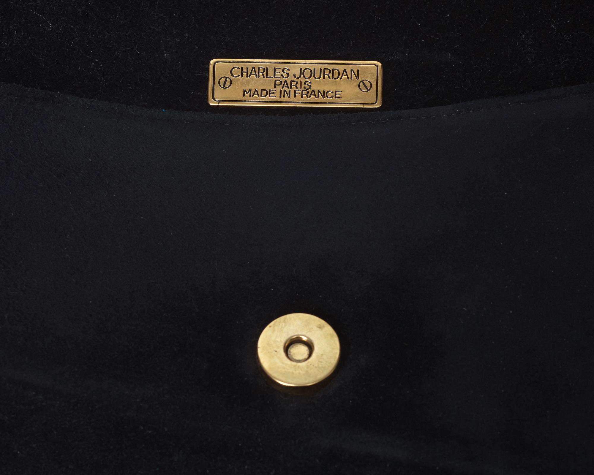 An evening bag and a pair of lady shoes by Charles Jourdan.