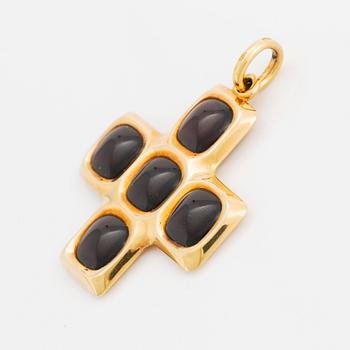 An 18K gold and garnet Pomellato cross.
