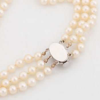 Three strand cultured pearl necklace, clasp with diamonds.