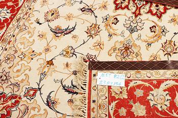 A semi-antique part silk Isfahan rug, a. 238 x 156 cm.