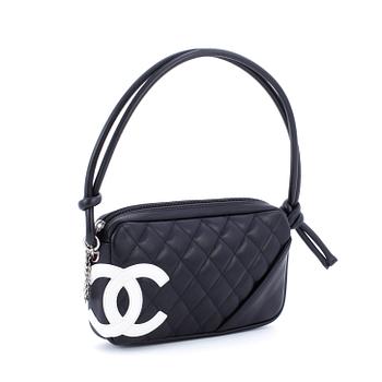 592. CHANEL, a black leather quilted pochette with short shoulder strap.