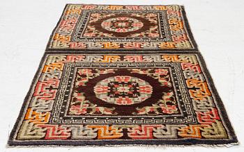 A Chinese two square rug, antique, c. 142 x 71 cm.