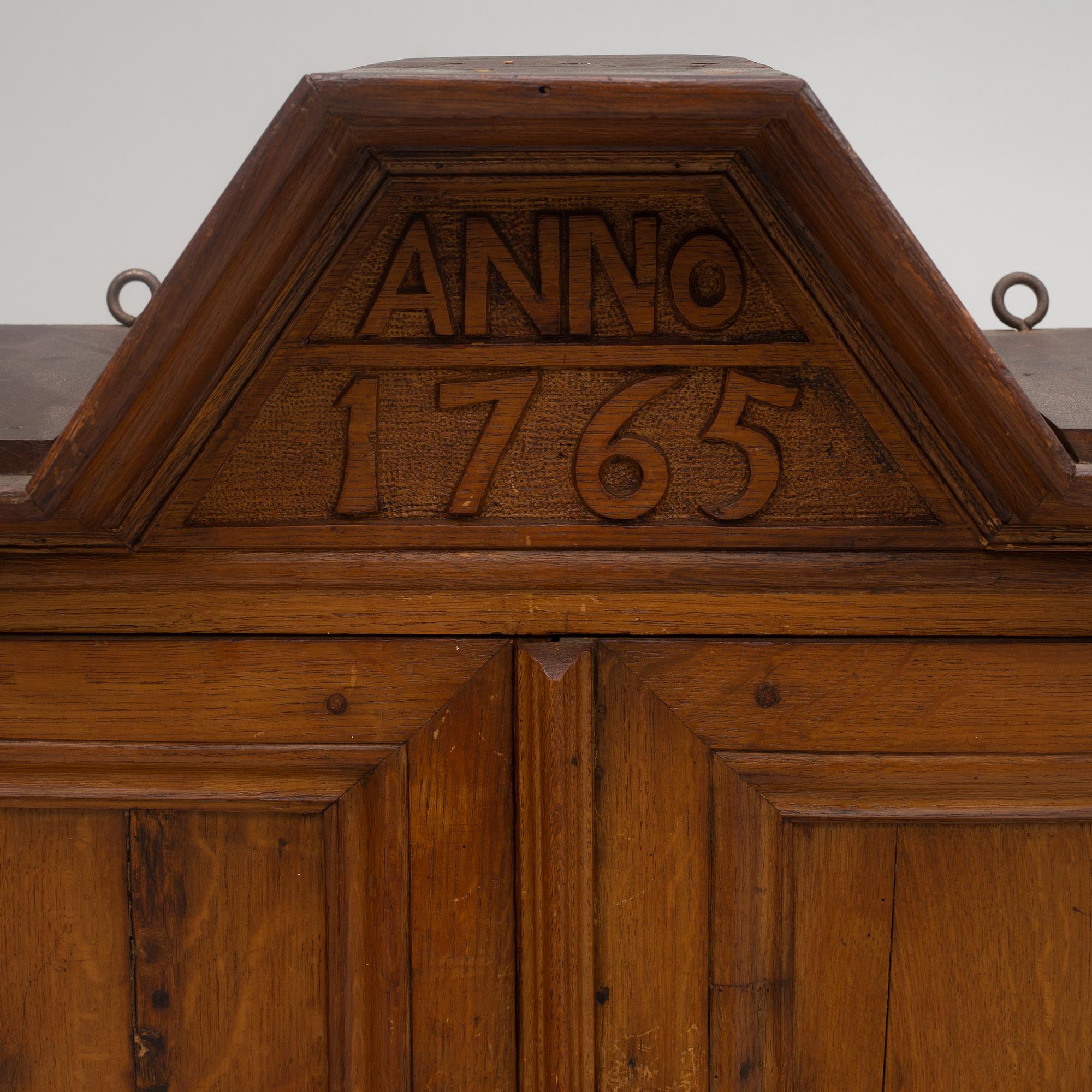A wall cabinet, dated 1765.