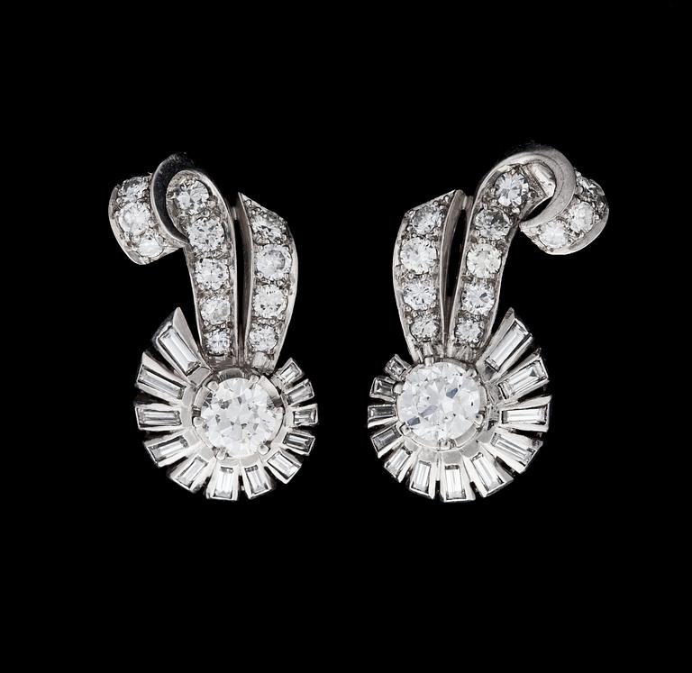 A pair of brilliant- and baguette cut diamond earrings, tot. app. 1.50 cts, 1940's.
