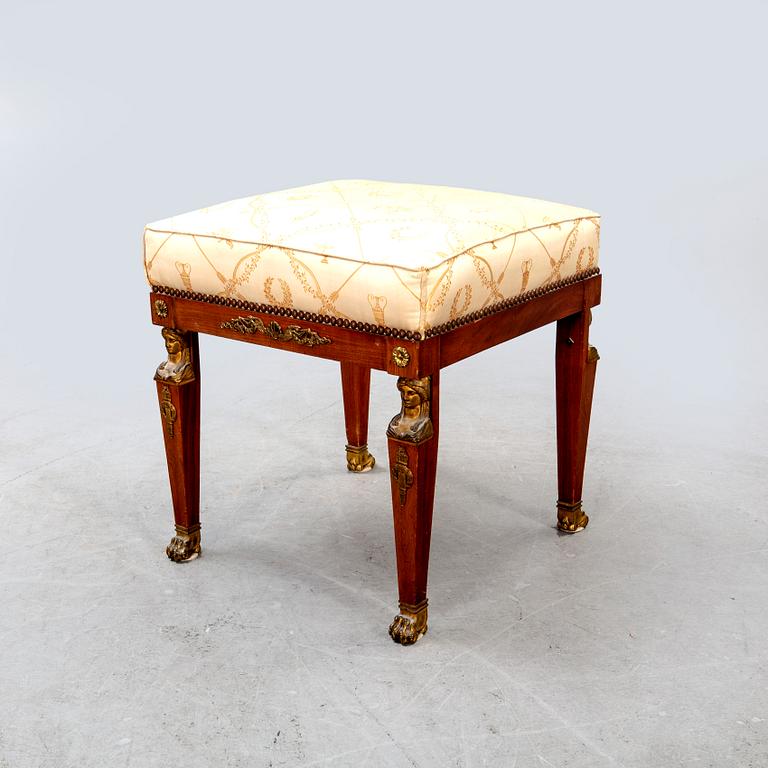 An Empire style mahogany stool around 1900.