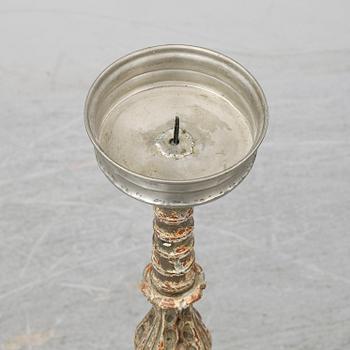 A wooden altar candlestick.