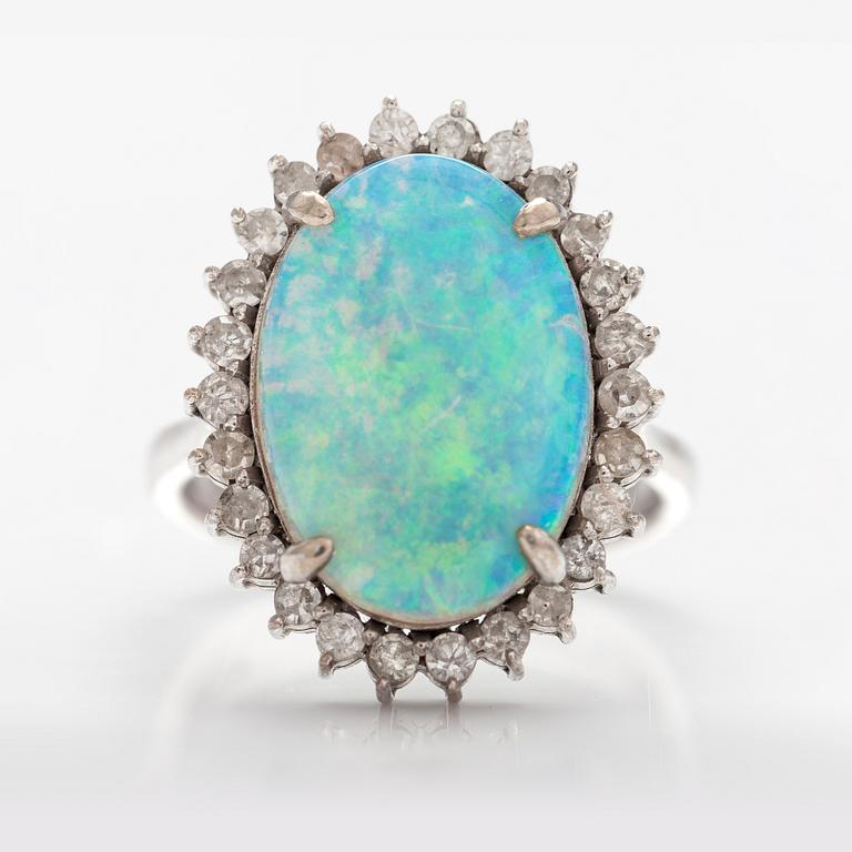 A 14K white gold ring with a probably real opal and diamonds ca. 0.65 ct in total.