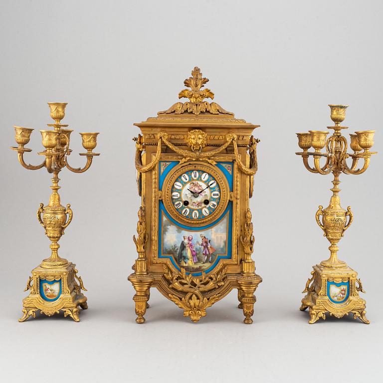 A late 19th century table clock and candelabra, probably France.