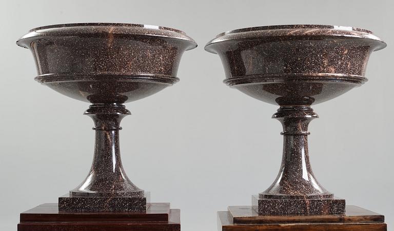 A pair of Swedish porpyry vases on wooden bases, Älvdalen, first half of the 19th century.