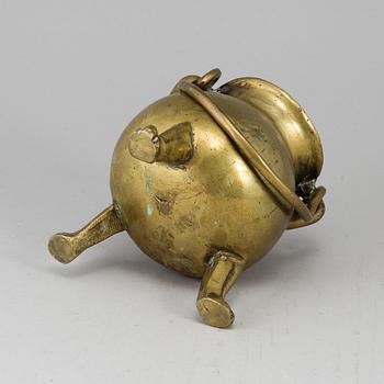 A 17th century brass bowl.