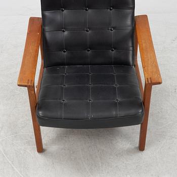 A 1970's teak and pvc coated fabric armchair and stool.