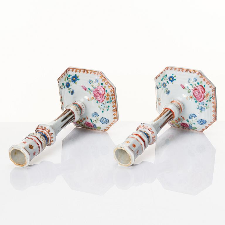 A pair of famille rose candles sticks, Qing dynasty, Qianlong (1736-95).
