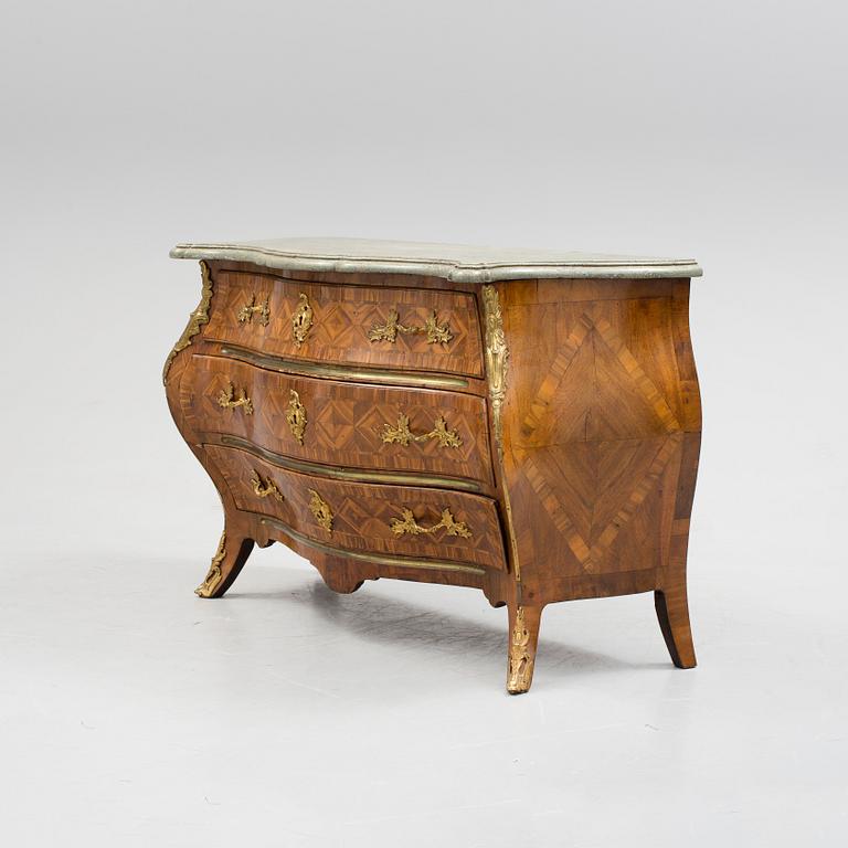 A 1700s rococo commode.