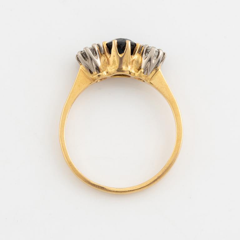 An 18K gold ring set with a sapphire and old-cut diamonds.