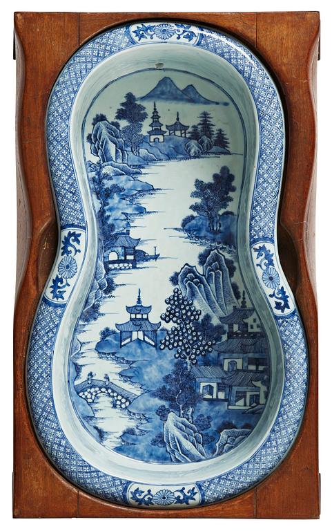 A blue and white bidet with a wooden stand, Qing dynasty, Qianlong (1736-95).